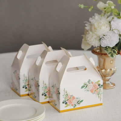 Decorative floral takeout boxes on a table with plates and a vase of flowers.