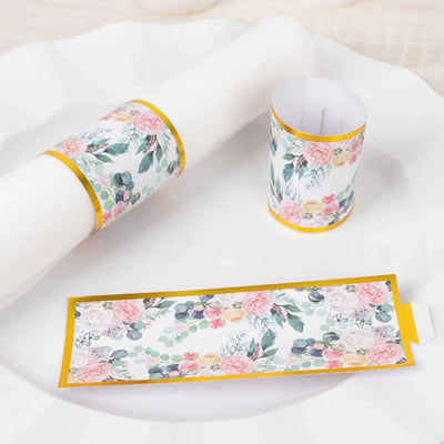 Floral paper wraps for table settings on a white plate.