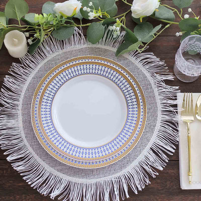 Elegant white plate with blue and gold design on a fringed table mat.