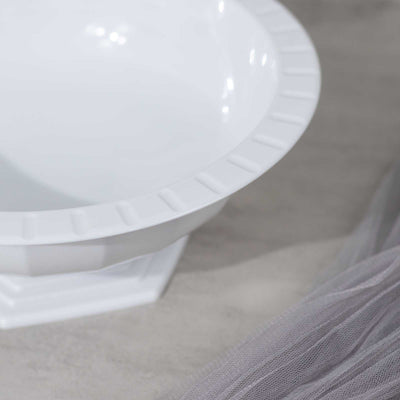 White decorative bowl with a textured rim and a smooth interior.