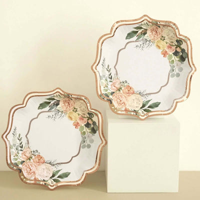 Floral decorative plates with scalloped edges on a neutral background.