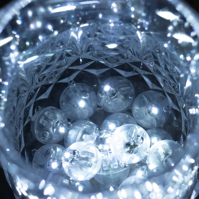 Crystal jar filled with glowing decorative orbs.