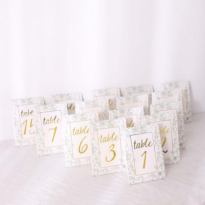 Elegant table number cards with floral design and gold accents.