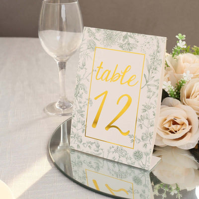 Elegant table number sign with floral design, gold accents, and clear stand.