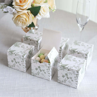 Decorative gift boxes with floral design, filled with colorful candies.