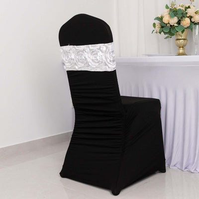 Black chair cover with white floral embellishment on a plain background.