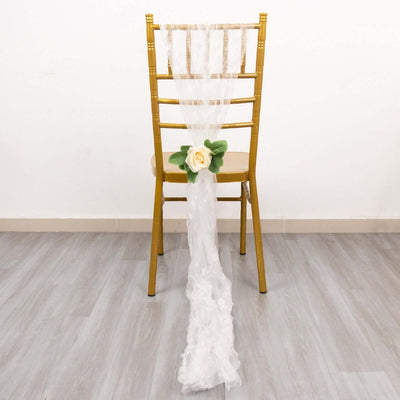 White chair decoration with lace draping and a rose flower accent.