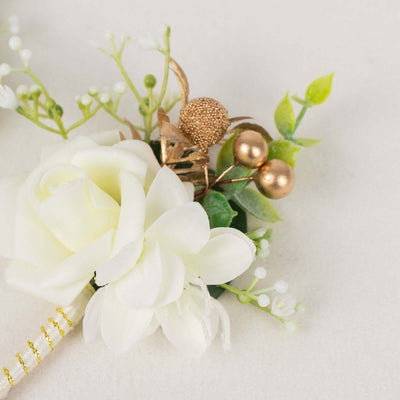 White flower bouquet with gold accents on a neutral background.