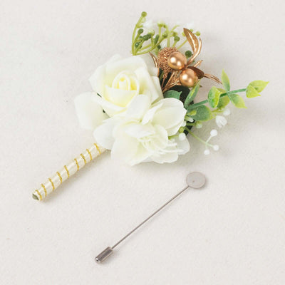 White floral boutonniere with gold accents and pin