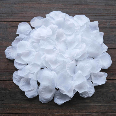White rose petal decorations arranged on a wooden surface.
