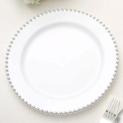 White plate with silver bead trim on a plain background