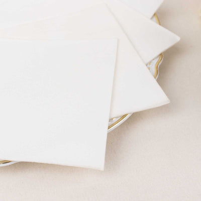 White paper sheets stacked on a decorative plate.