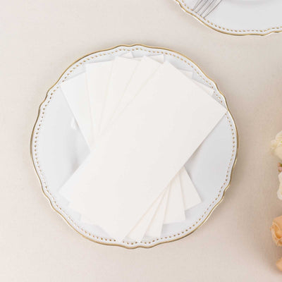 White envelopes arranged on an elegant plate.