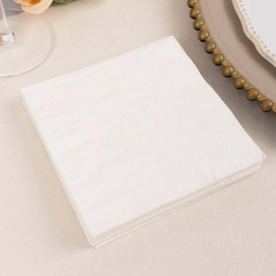 White disposable napkins stacked on a table.