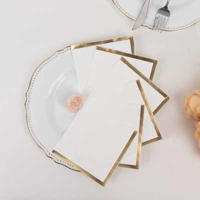 Elegant blank notecards with gold trim on a decorative plate.