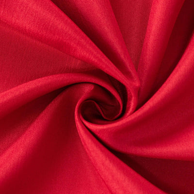 Red fabric texture close-up showing soft, smooth material details.