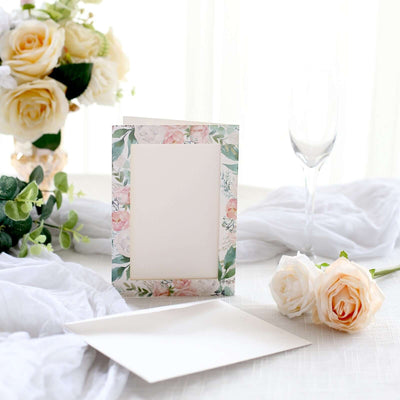 Floral photo frame with blank space, surrounded by roses and a glass.