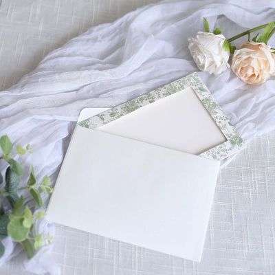 Elegant envelope with floral liner on soft fabric backdrop.