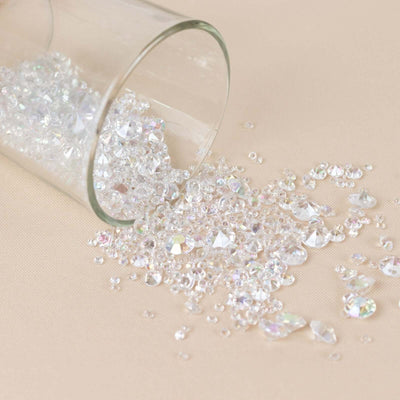 Scattered clear rhinestones spilling from a glass jar.