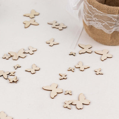 Wooden butterfly cutouts arranged on a surface for crafting or decoration.