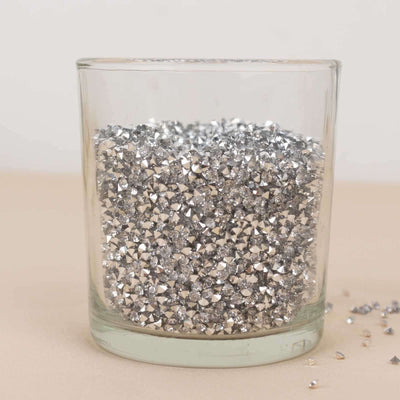 Silver rhinestone embellishments in a clear glass jar.