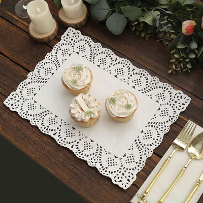 White lace doily with cupcakes on a wooden table.
