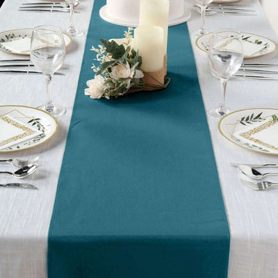 Teal table runner on a dining table set with plates and glasses.