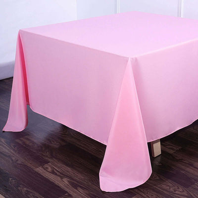 Pink tablecloth draped on a table with a smooth finish.