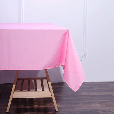 Pink tablecloth draped over a wooden table