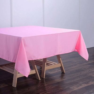 Pink tablecloth draped over a wooden table