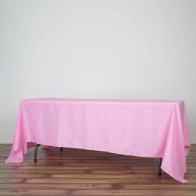Pink tablecloth draped over a table in a minimalist setting.