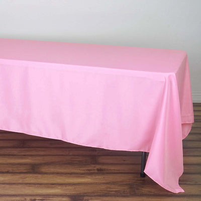 Pink tablecloth draped over a table, showcasing smooth fabric texture.