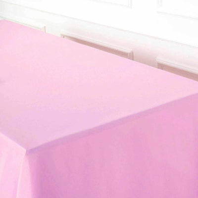 Pink tablecloth draped over a table in a light setting.