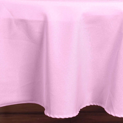 Pink tablecloth draped elegantly on a wooden surface.