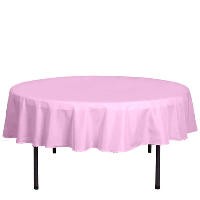 Round pink tablecloth on a table.