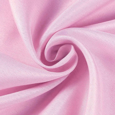 Pink fabric swirl showcasing smooth texture and vibrant color.
