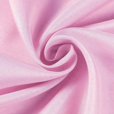 Pink fabric swirl showcasing smooth texture and drape.