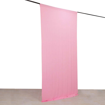 Pink fabric backdrop hanging from a rod for photography or decor use.