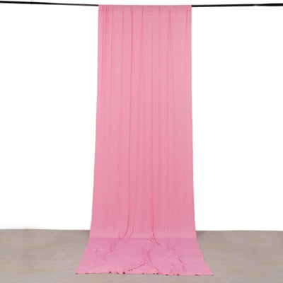 Pink fabric backdrop hanging in a studio setting