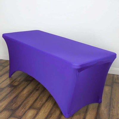 Purple stretch table cover on a wooden floor.