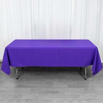 Purple tablecloth draped over a rectangular table in a studio setting.