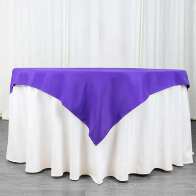Purple tablecloth draped over a white table.