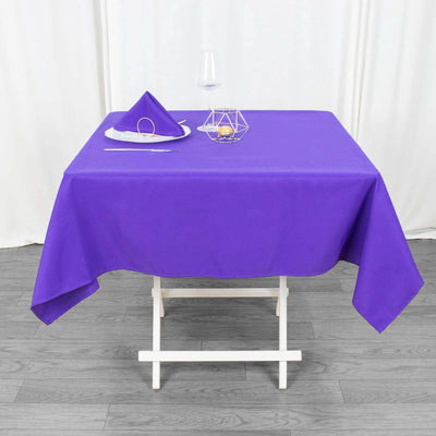 Purple tablecloth with matching napkin and decorative elements on a table.