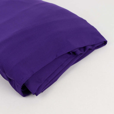 Purple folded fabric on a plain background.