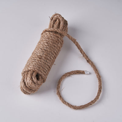 Natural jute rope roll on a plain background