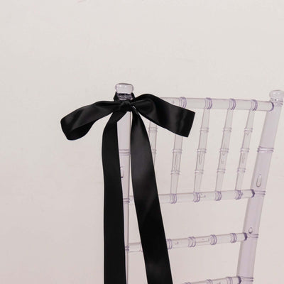 Clear chiavari chair with black satin ribbon bow on back
