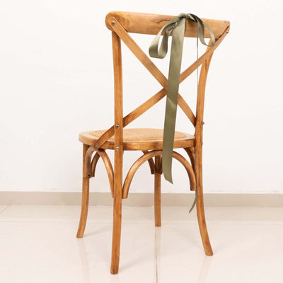Wooden dining chair with a green ribbon on the back