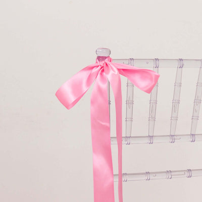 Clear chiavari chair with a pink satin ribbon bow