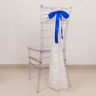 Transparent chair with white and blue ribbon decoration.