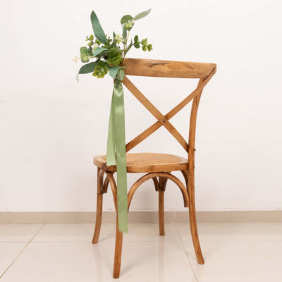 Wooden cross-back chair with floral arrangement and ribbon detail.